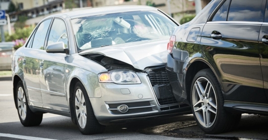 silver car crashed into the rear of a black car