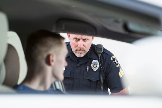 Police officer arresting driver on DUI charges